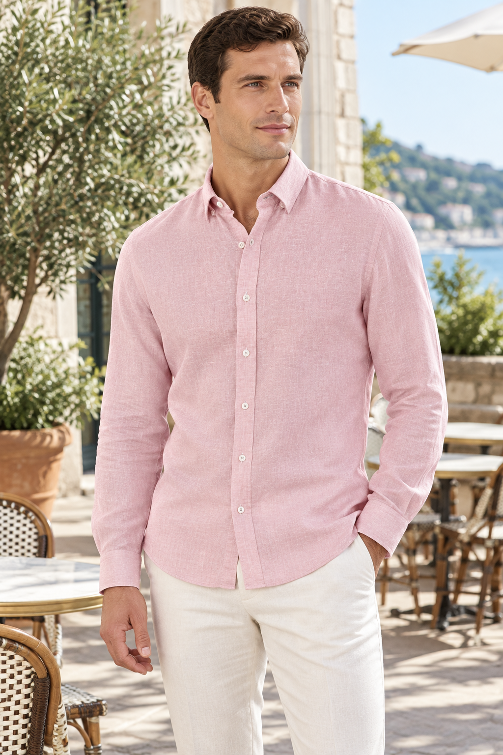 Model wearing Brooksfield BFS1176 dusty pink relaxed slim fit linen shirt with off-white trousers on a sunlit terrace