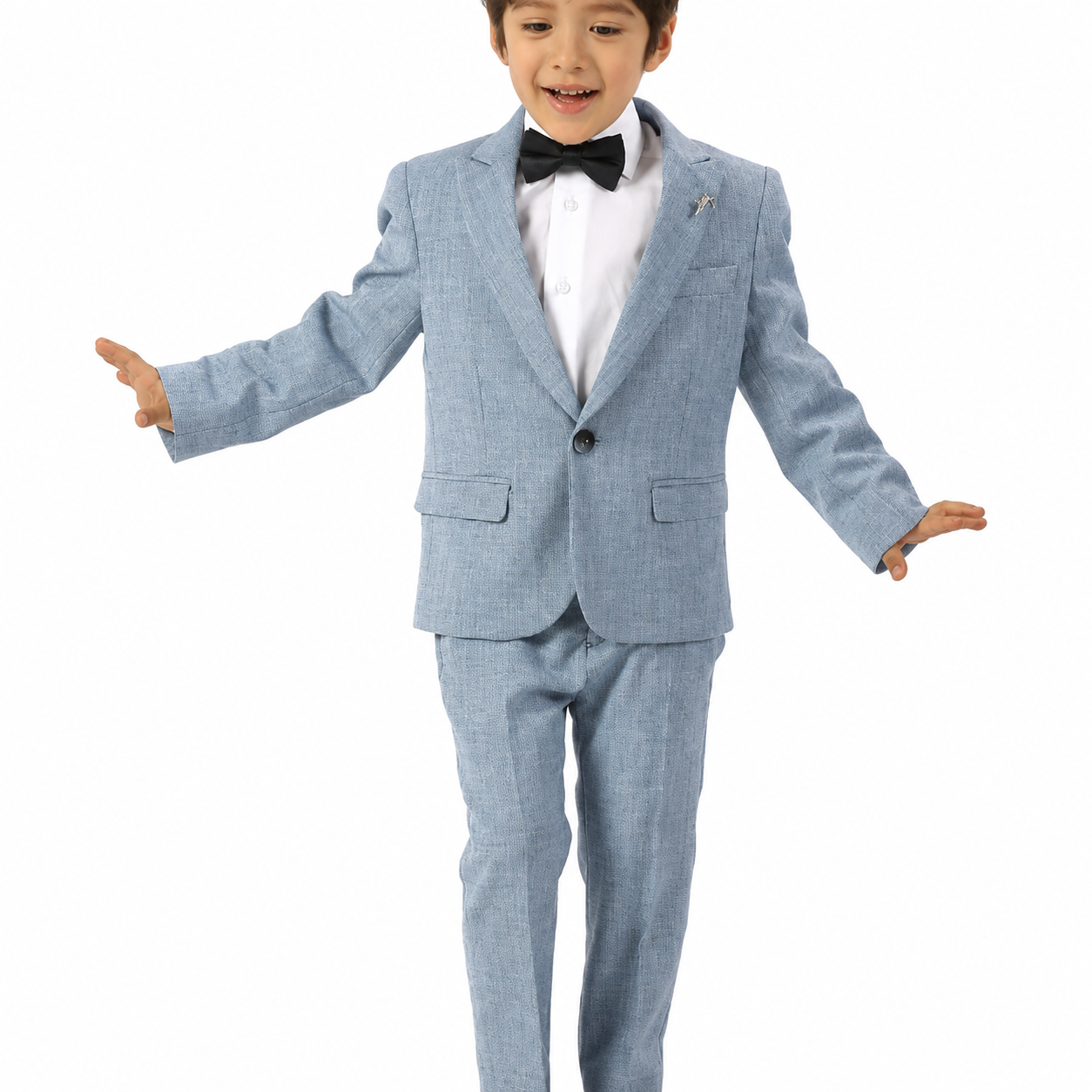 A young boy modeling a light blue textured three-piece suit with a white dress shirt, black bow tie, and a small lapel pin, set against a plain white background.